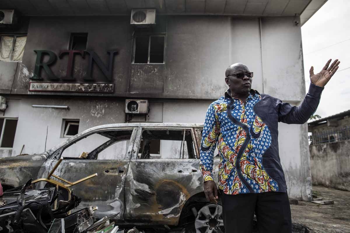 Pastor Georges Bruno Ngoussi, the CEO of the RTN (Radio Television Nazareth) gestures in front of the charred remains of his car in the courtyard of the studios on September 4, 2016 in Libreville. Pastor Georges Bruno Ngoussi, the CEO of the RTN (Radio Television Nazareth) gestures in front of the charred remains of his car in the courtyard of the studios on September 4, 2016 in Libreville.