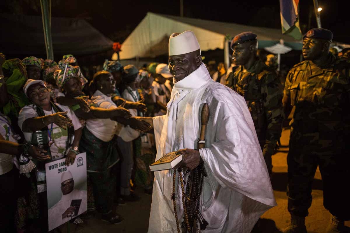 Gambia's incumbent President Yahya Jammeh (C), leader of the APRC (The Alliance for Patriotic Reorientation and Construction), smiles while being greeted by supporters as he arrives at a campaign rally in Brikama, on November 24, 2016, ahead of the Decemb