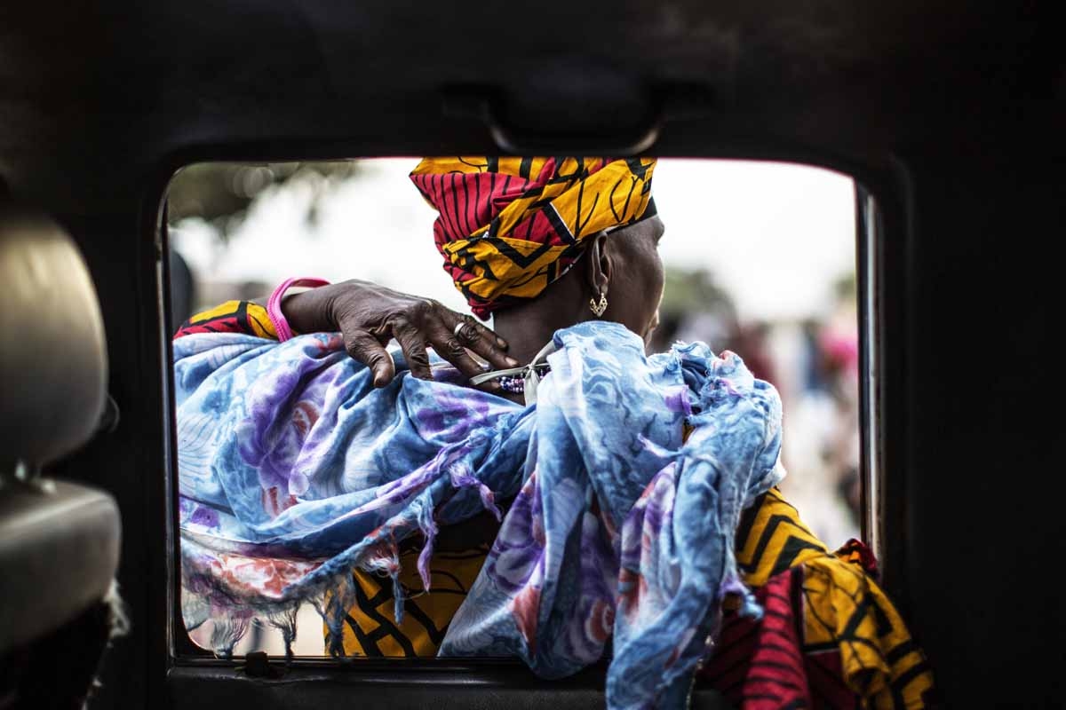 A supporters of Adama Barrow, the flag-bearer of the coalition of the seven opposition political parties in Gambia, leans on the door of a car in the Buffer Zone district of Talinding on November 29, 2016 on the last day of the presidential campaign in Ga