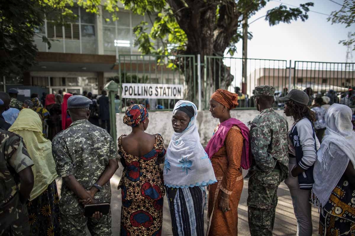 Voters queue at a polling station in Banjul on December 1, 2016, during presidential elections.
