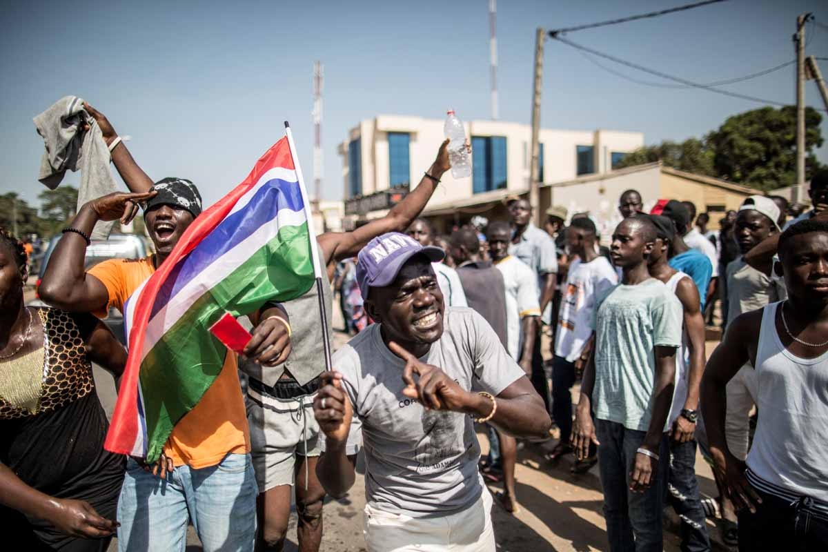 A man waves a Gambian flag as he celebrates the victory of Gambia's opposition candidate Adama Barrow during the Presidential Elections on December 2, 2016, in Serekunda, Banjul.