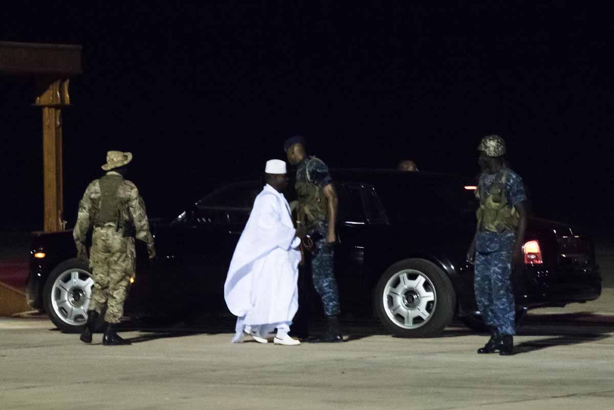Former president Yaya Jammeh (C), the Gambia's leader for 22 years, walks towards the plane as he leaves the country on 21 January 2017 in Banjul airport.