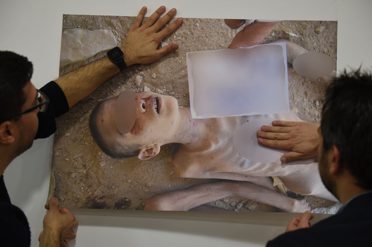 Members of the Syrian Organisation for the Victims of War (SOVW) display pictures documenting the torture of detainees inside the Assad regimeâs prisons and detention centres, on March 17, 2016 in Geneva. The photographs were taken by a former military
