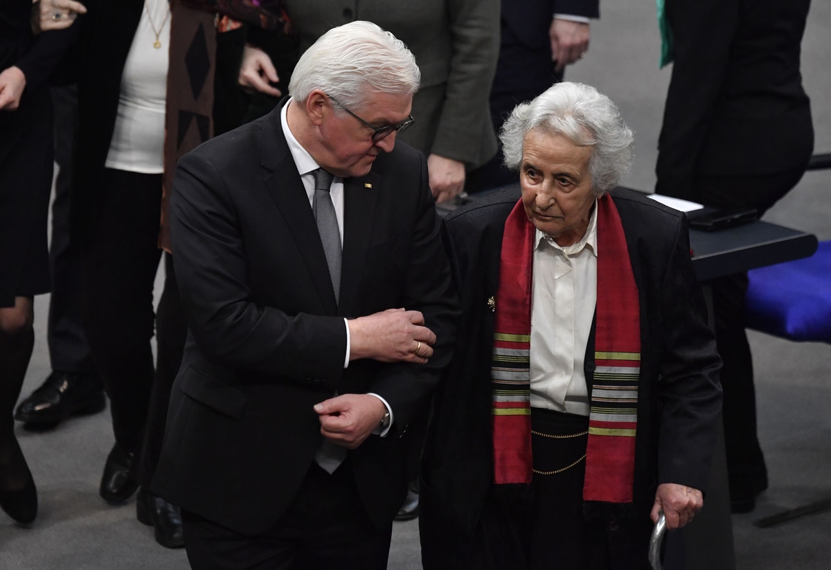 German President Frank-Walter Steinmeier and Holocaust survivor and cellist Anita Lasker-Wallfisch arrive for the annual ceremony in memory of Holocaust victims and survivors, on January 31, 2018, at the Bundestag (Germany's lower house of parliament), in