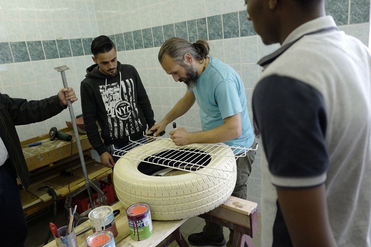 Local artist Vincenzo Panico (2ndR) directs a workshop for refugees at Biotec, a local association that provides activities for refugees and socially disadvantaged locals in Freital, just outside of Dresden on September 29, 2016. Local artist Vincenzo Panico (2ndR) directs a workshop for refugees at Biotec, a local association that provides activities for refugees and socially disadvantaged locals in Freital, just outside of Dresden on September 29, 2016.