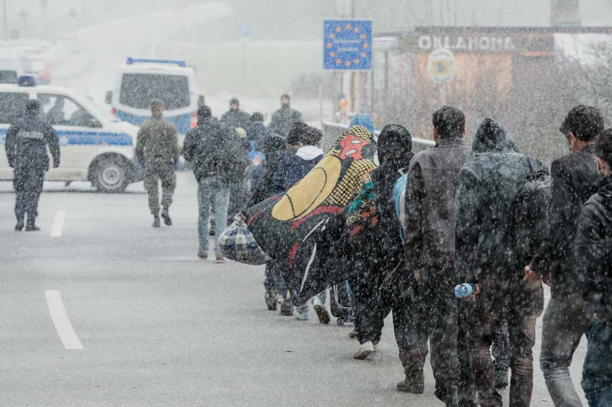 Migrants walk down a road at the Austrian - German border during snowfall near Wegscheid, southern Germany, on November 21, 2015. Migrants walk down a road at the Austrian - German border during snowfall near Wegscheid, southern Germany, on November 21, 2015.