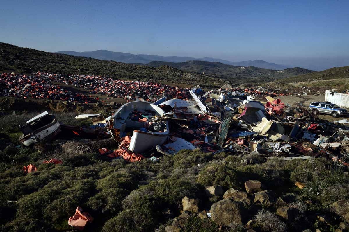 Portugese officers serving for the European Border and Coast Guard Agency and Greek patrol along a dump with thousands of discarted lifejackets and boats used by migrants, during their patrol in Aghios Stephanos at the north part of the island of Lesbos