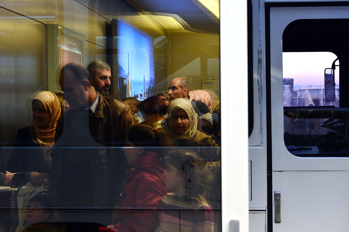 Refguees wait at the airport in Athens to board a special charter plane bound for France in the frames of the EU relocation program for refugees on November 3, 2016.