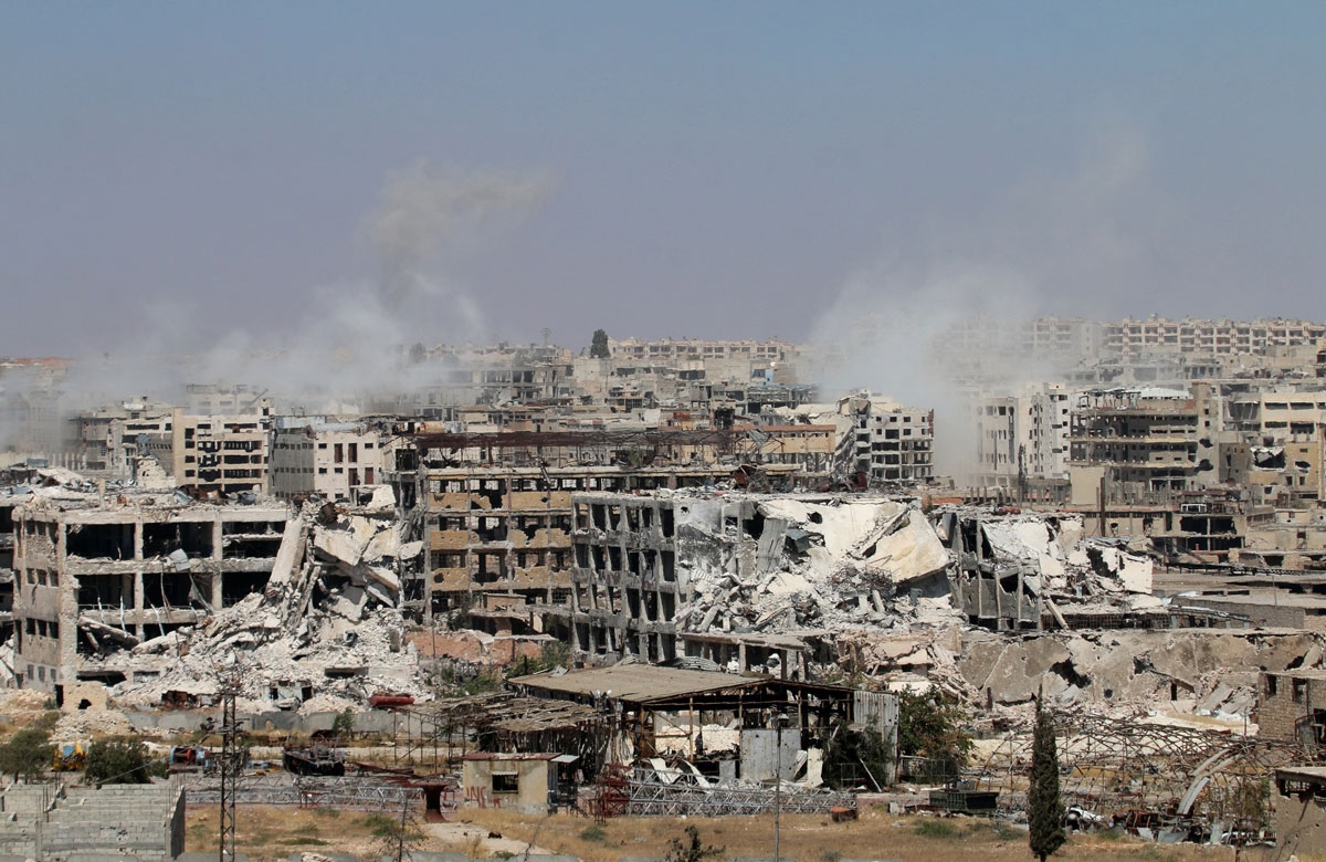 Smoke billows from buildings during an operation by Syrian government forces to retake control of the rebel-held district of Leramun, on the northwest outskirts of Aleppo, on July 26, 2016