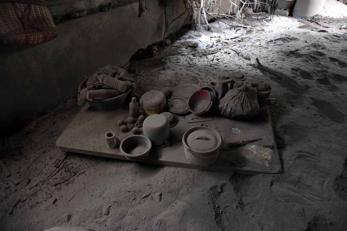 Inside view of abandoned houses in the ash-covered village of San Miguel Los Lotes, which was also flooded with hot mud that descended from the Fuego Volcano, in Escuintla department, about 35 km southwest of Guatemala City, on June 8, 2018.The threat of