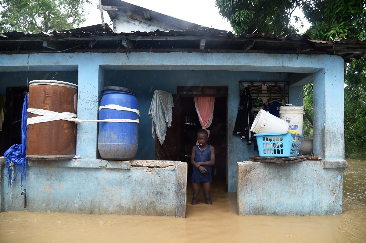 Franki stands in his flooded home following the overflowing of La Rouyonne river in the commune of Leogane, south of Port-au-Prince, October 5, 2016. Franki stands in his flooded home following the overflowing of La Rouyonne river in the commune of Leogane, south of Port-au-Prince, October 5, 2016.