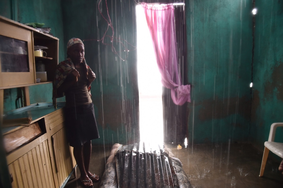 Judeline stands as the rain enters her house through the roof damaged by Hurricane Matthew, in Port-a-Pimet, Les Cayes, Haiti on October 14, 2016. Judeline stands as the rain enters her house through the roof damaged by Hurricane Matthew, in Port-a-Pimet, Les Cayes, Haiti on October 14, 2016.