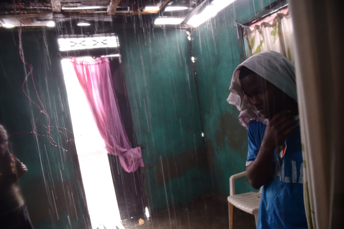 Judelin looks as the rain enters her house through the roof that was damaged by Hurricane Matthew, in Port-a-Pimet, Les Cayes, Haiti on October 14, 2016. Judelin looks as the rain enters her house through the roof that was damaged by Hurricane Matthew, in Port-a-Pimet, Les Cayes, Haiti on October 14, 2016.