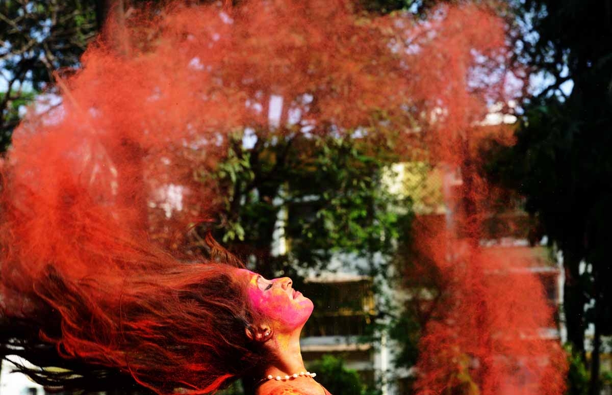 Indian students play with coloured powders as they celebrate 'holi' or the 'festival of colours' during a special function in Kolkata on March 12, 2017. / AFP PHOTO / Dibyangshu SARKAR