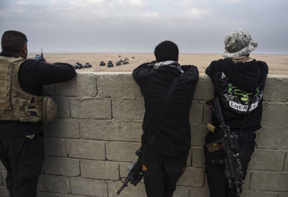 Members of the Iraqi Counter Terrorism Service (CTS) look out at their comrades driving near the village of Bazwaya, on the eastern edges of Mosul, as they advance towards Iraq's last remaining Islamic State (IS) group stronghold on October 31, 2016. Members of the Iraqi Counter Terrorism Service (CTS) look out at their comrades driving near the village of Bazwaya, on the eastern edges of Mosul, as they advance towards Iraq's last remaining Islamic State (IS) group stronghold on October 31, 2016.