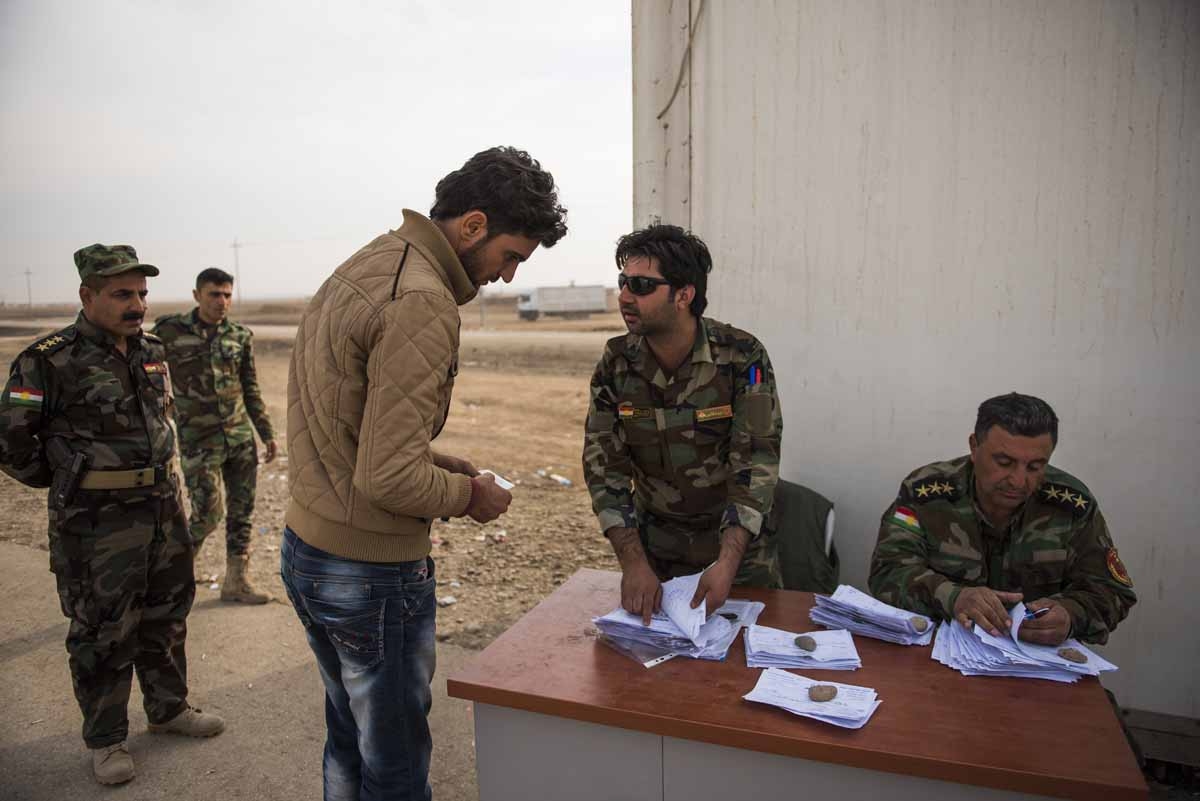 A man tries to convince Peshmerga forces to let him pass through the Iraqi Kurdish Shaqouli checkpoint, some 35 kilometres east of Mosul, on November 10, 2016. A man tries to convince Peshmerga forces to let him pass through the Iraqi Kurdish Shaqouli checkpoint, some 35 kilometres east of Mosul, on November 10, 2016.