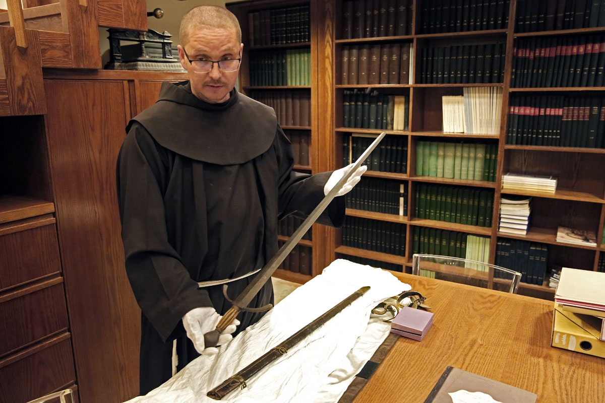 Franciscan friar Serge Loktionov shows the sword used since the XIII century by the Custos (the chiefs of the Franciscans in the Holy Land) to anoint knights of the Holy Sepulchre.