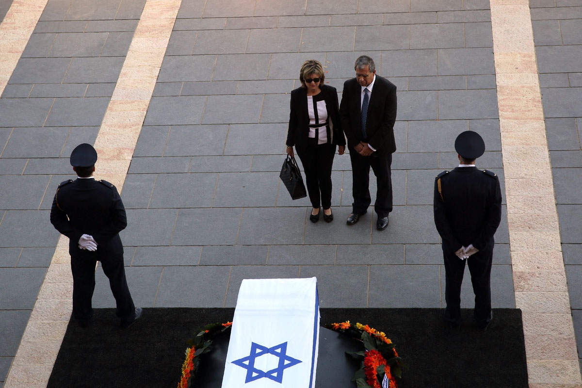 A member of parliament pays his respects next to the coffin of former Israeli president Shimon Peres at the Knesset, Israel's Parliament, in Jerusalem on September 29, 2016.