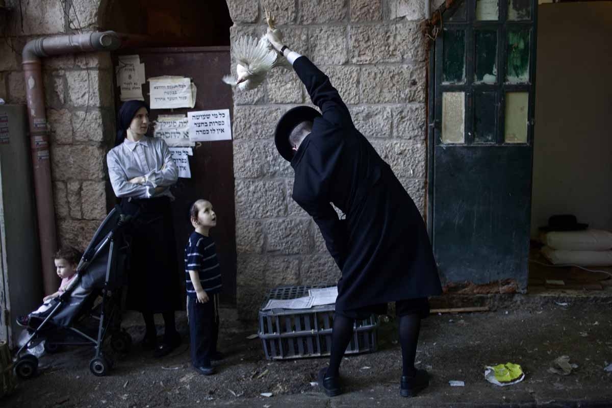 An Ultra-Orthodox Jewish man swings a chicken over his head during the Kaparot ceremony in Mea Shearim neighborhood of Jerusalem on October 6, 2011.
