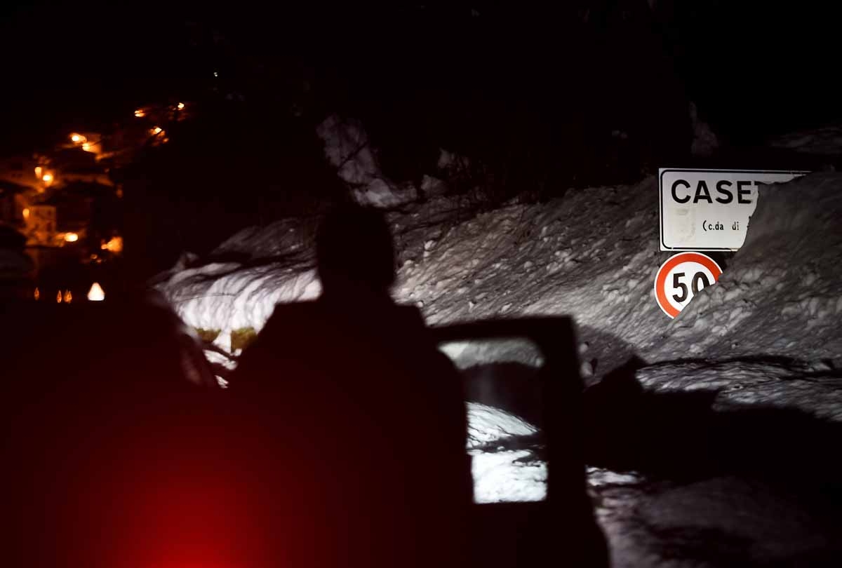 Snow covers a road sign of Casette, part of the village of Castelli, some 15 km from the site where an avalanche engulfed the mountain hotel Rigopiano in Farindola, near Penne, in earthquake-ravaged central Italy, on January 22, 2017.