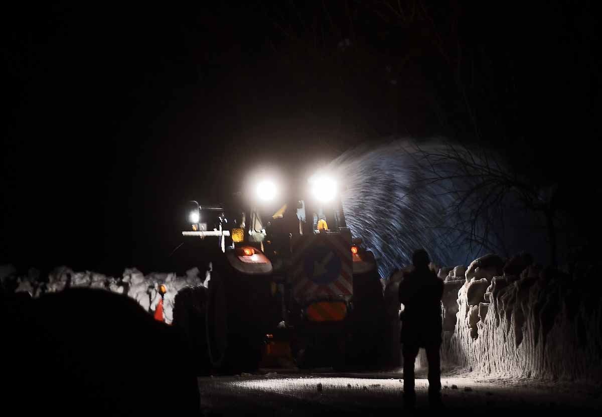A group of volunteers from Ticino, Switzerland, clear the road with their own snow plow in the village of Castelli, some 15 km from the site where an avalanche engulfed the mountain hotel Rigopiano in Farindola, near Penne, in earthquake-ravaged central I