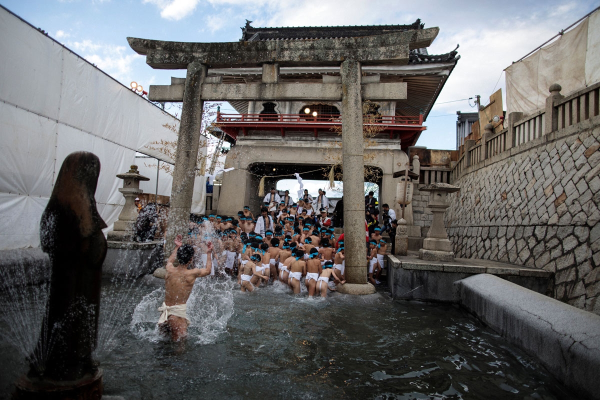 In this picture taken on February 18, 2017, Japanese boys step out of the fountain after being purified during the boys' event in the annual Naked Man Festival or 'Hadaka Matsuri'at Saidaiji Temple in Okayama, western Japan.
