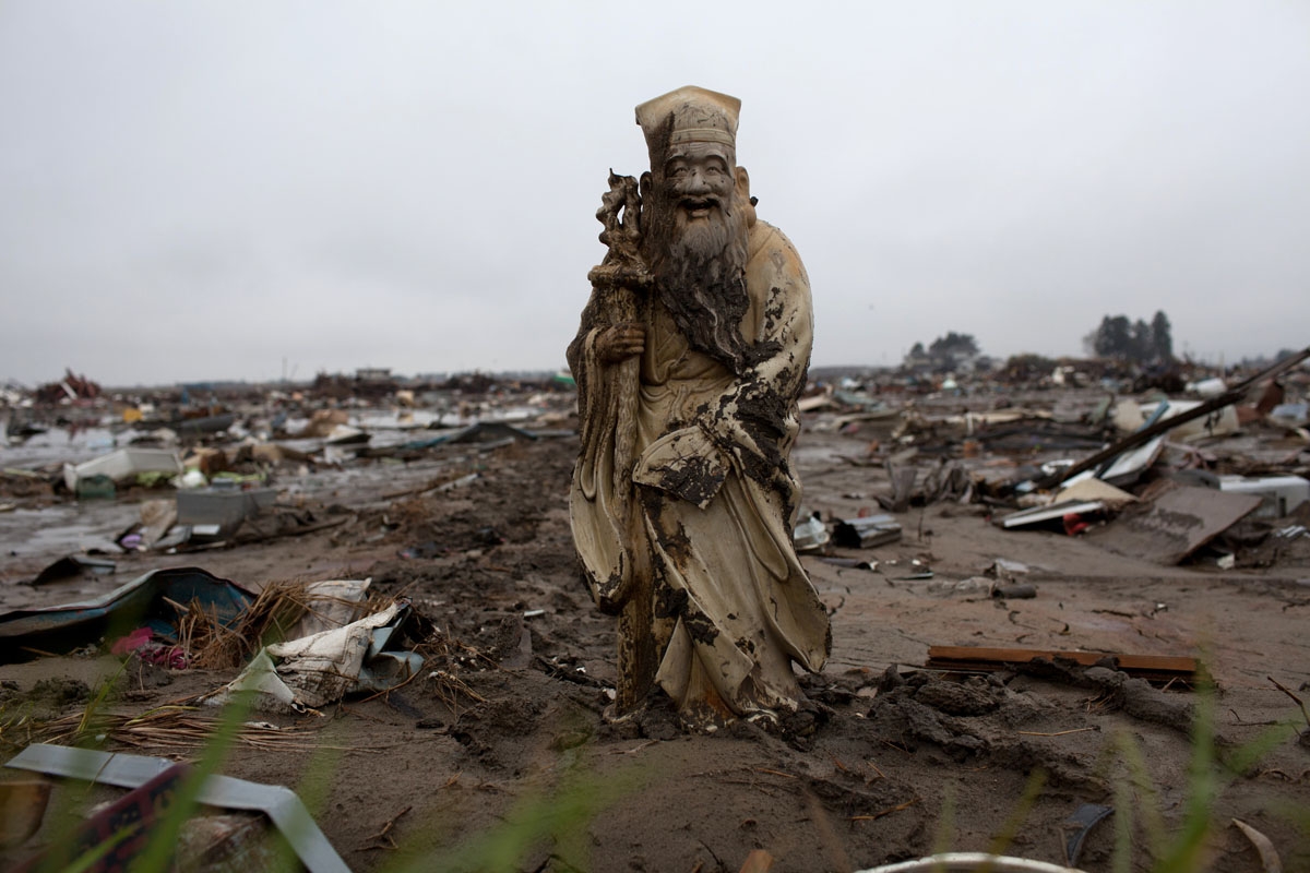 A statue stands in a rice field devastated by the March 11 tsunami in Natori in Miyagi prefecture on April 23, 2011.