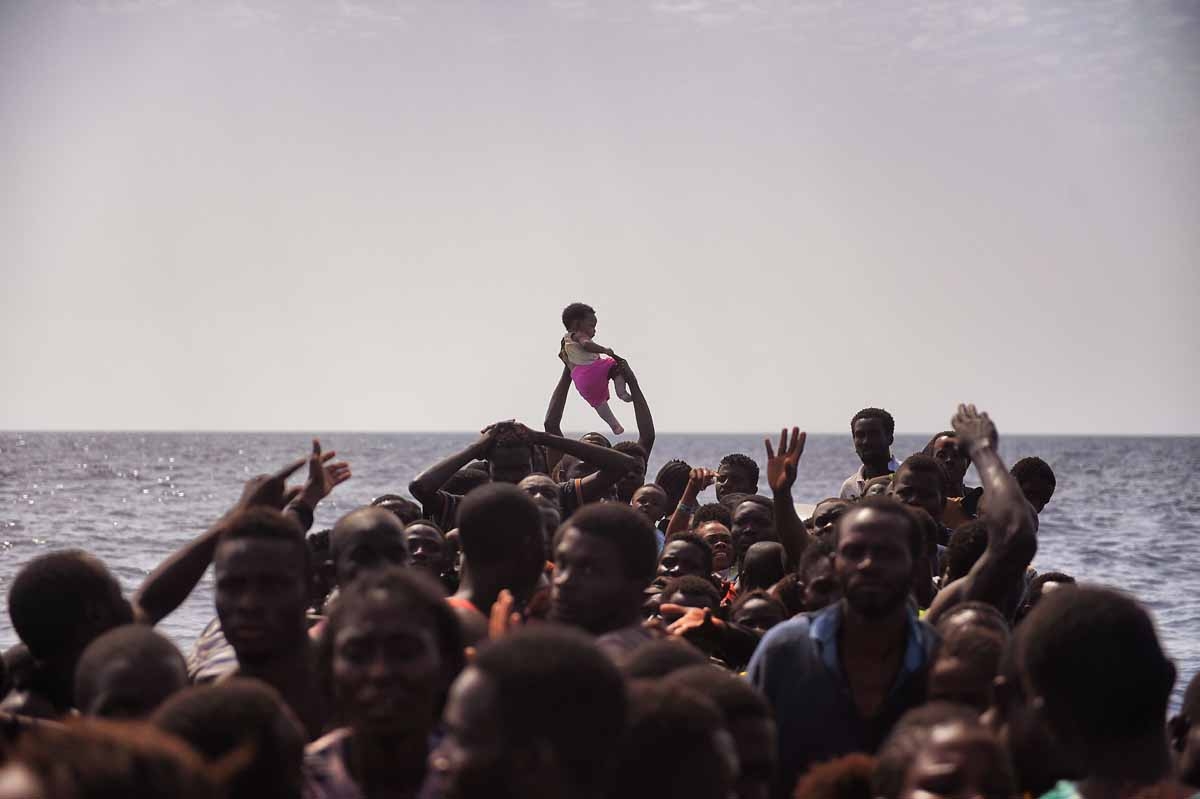Migrants wait to be rescued by members of Proactiva Open Arms NGO in the Mediterranean Sea, some 12 nautical miles north of Libya, on October 4, 2016. Migrants wait to be rescued by members of Proactiva Open Arms NGO in the Mediterranean Sea, some 12 nautical miles north of Libya, on October 4, 2016.