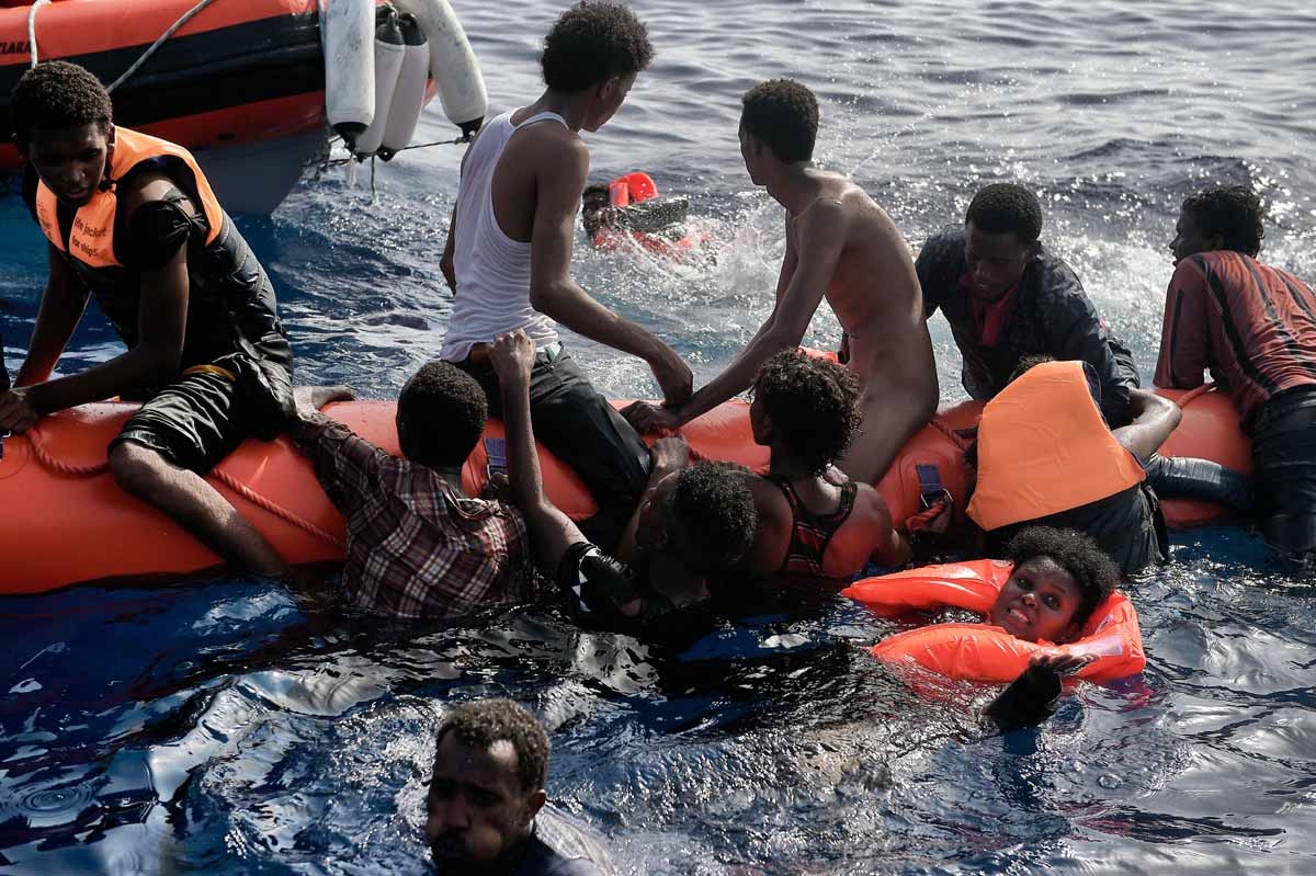 Migrants wait to be rescued by members of Proactiva Open Arms NGO in the Mediterranean Sea, some 12 nautical miles north of Libya, on October 4, 2016. Migrants wait to be rescued by members of Proactiva Open Arms NGO in the Mediterranean Sea, some 12 nautical miles north of Libya, on October 4, 2016.