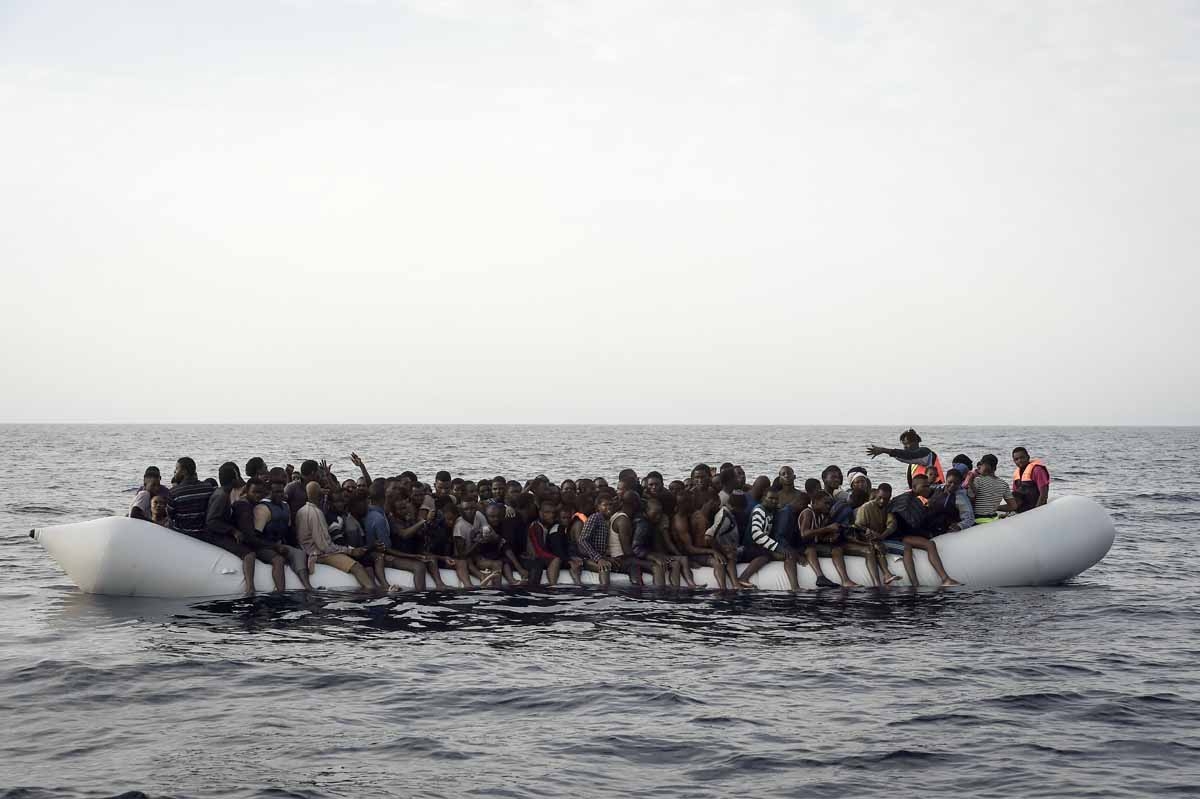 Migrants wait to be rescued by members of Proactiva Open Arms NGO in the Mediterranean Sea, some 12 nautical miles north of Libya, on October 4, 2016. Migrants wait to be rescued by members of Proactiva Open Arms NGO in the Mediterranean Sea, some 12 nautical miles north of Libya, on October 4, 2016.