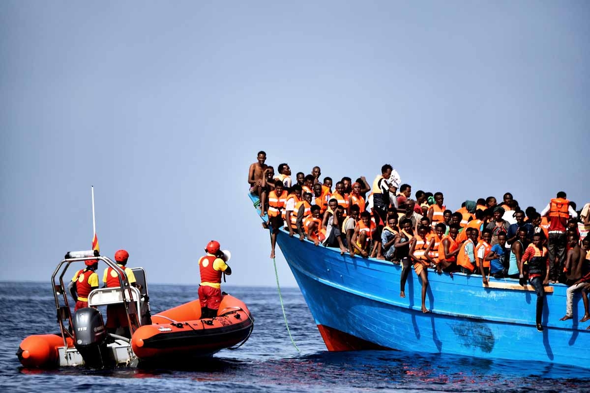 Members of Spanish humanitarian NGO Proactiva Open Arms, try to calm refugees and migrants during a rescue operation off the coast of Libya on October 4, 2016. Members of Spanish humanitarian NGO Proactiva Open Arms, try to calm refugees and migrants during a rescue operation off the coast of Libya on October 4, 2016.