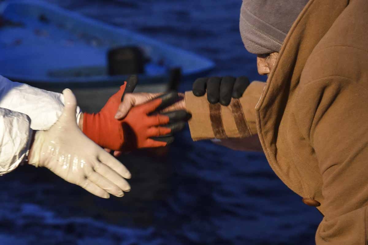 Members of Maltese NGO MOAS and the Italian Red Cross help an elderly woman to board the Topaz Responder ship during a rescue operation of migrants and refugees, off the Libyan coast in the Mediterranean Sea, on November 3, 2016. Members of Maltese NGO MOAS and the Italian Red Cross help an elderly woman to board the Topaz Responder ship during a rescue operation of migrants and refugees, off the Libyan coast in the Mediterranean Sea, on November 3, 2016.