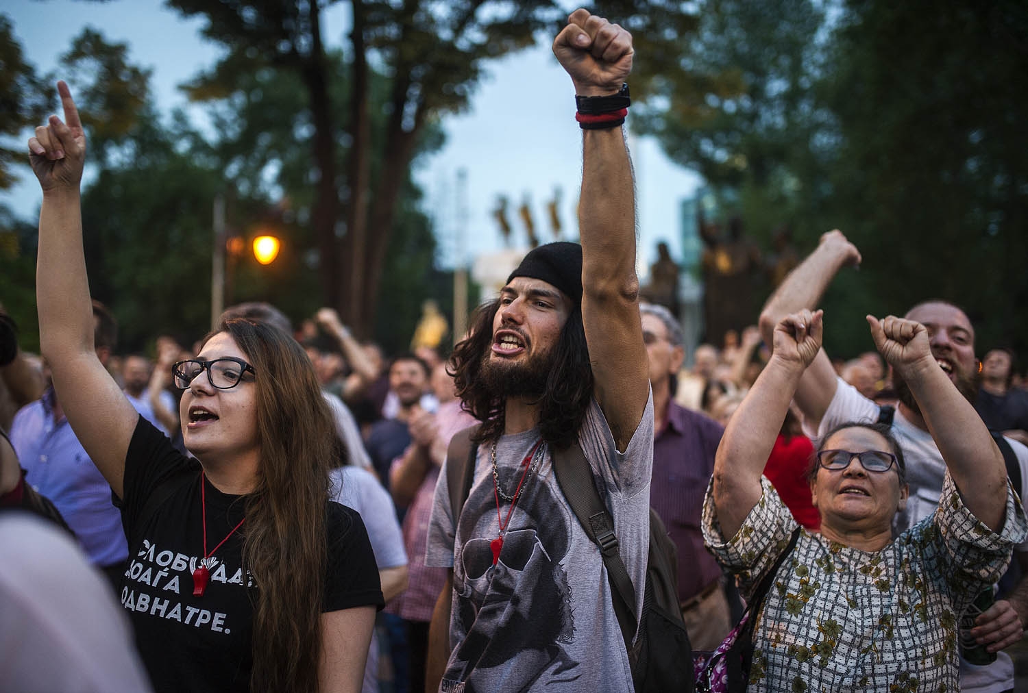 Protesters raise their hands in front of the Parliament in Skopje on April 18, 2016