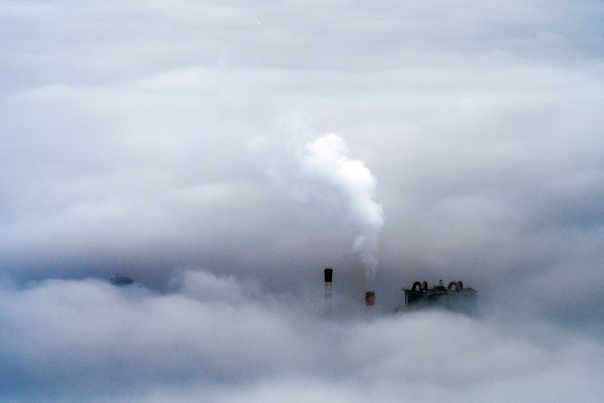 A picture taken from Vodno Mountain shows smoke rising from chimneys of a factory in an area with a high level of air pollution in Skopje on December 15, 2017.