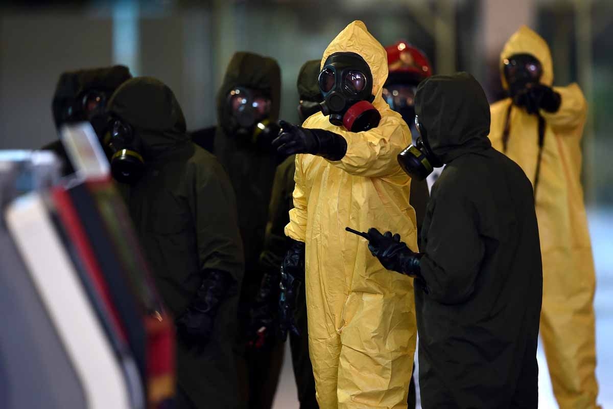 Members of Malaysia's Hazmat team conduct a decontamination operation at the departures terminal of the Kuala Lumpur International Airport 2 (KLIA 2) in Sepang on February 26, 2017.