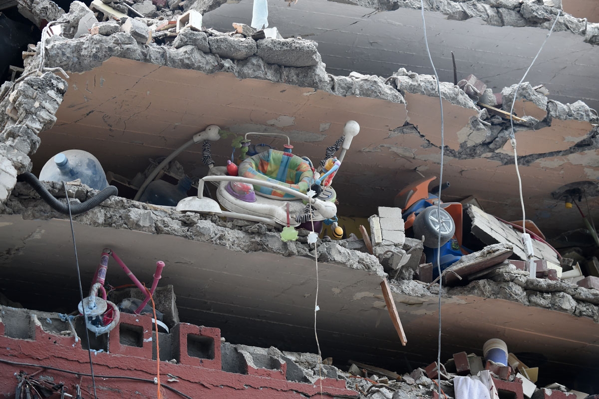 Toys and a baby walker are seen in a building flattened by the strong quake that hit central Mexico on the eve, taken on September 20, 2017 as the searches for survivors continues.