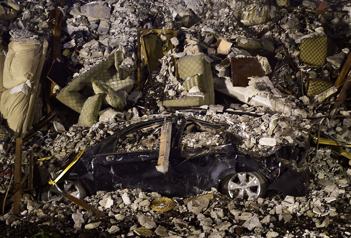 A crushed car and sofas are seen under a pile of rubble from a collapsed building in Mexico City on September 21, 2017, two days after a strong quake hit central Mexico.