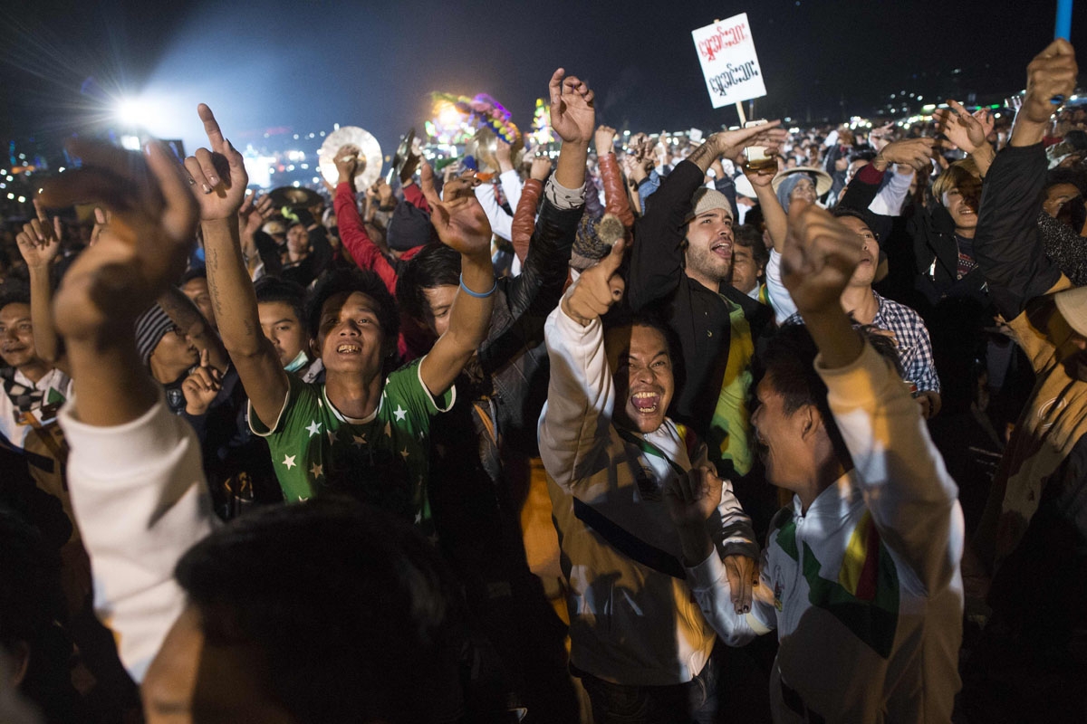 This picture taken on November 11, 2016 shows participants celebrating as a balloon carrying fireworks takes off during the Tazaungdaing Lighting Festival at Taunggyi in Myanmar's northeastern Shan State.