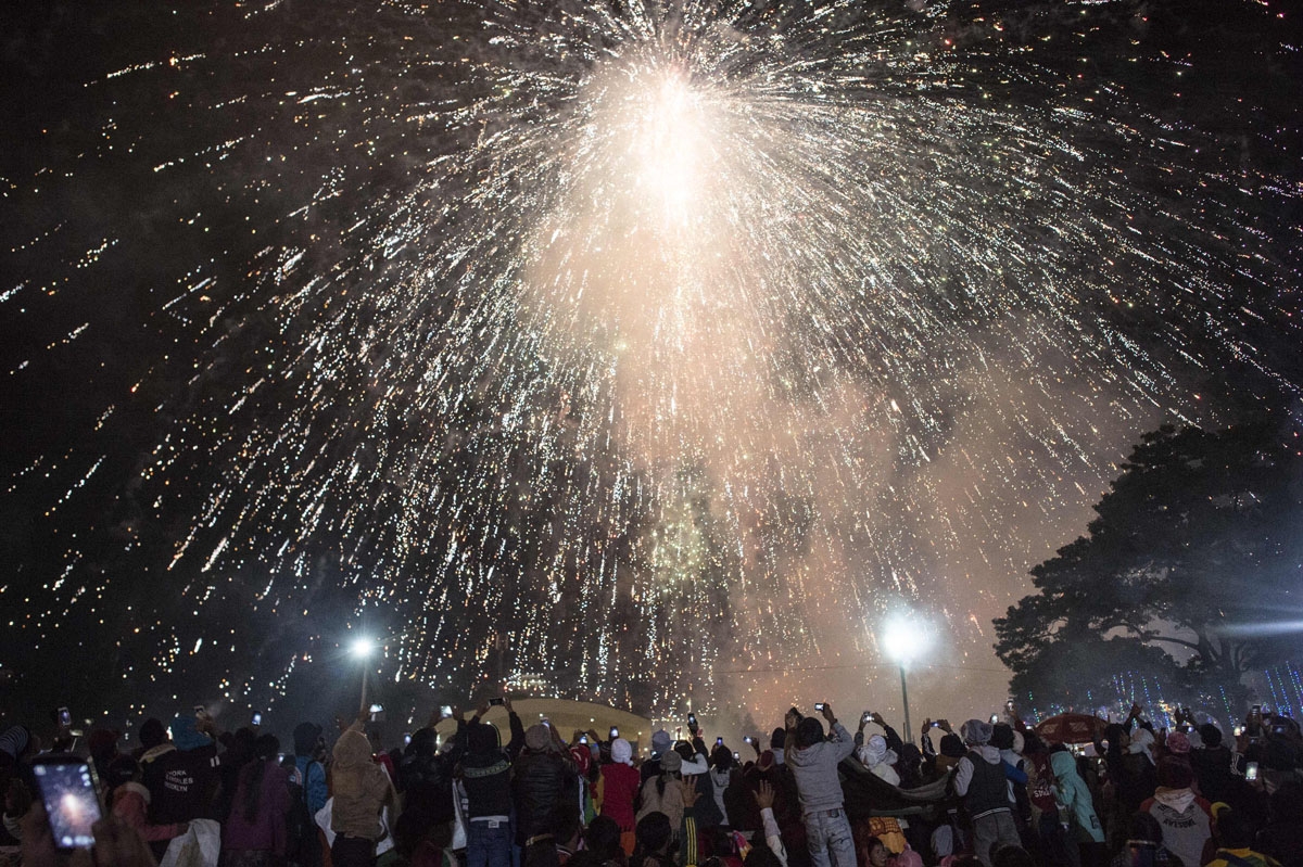 This picture taken on November 12, 2016 shows fireworks being ignited while carried off by a hot air balloon during the Tazaungdaing Lighting Festival at Taunggyi in Myanmar's northeastern Shan State.