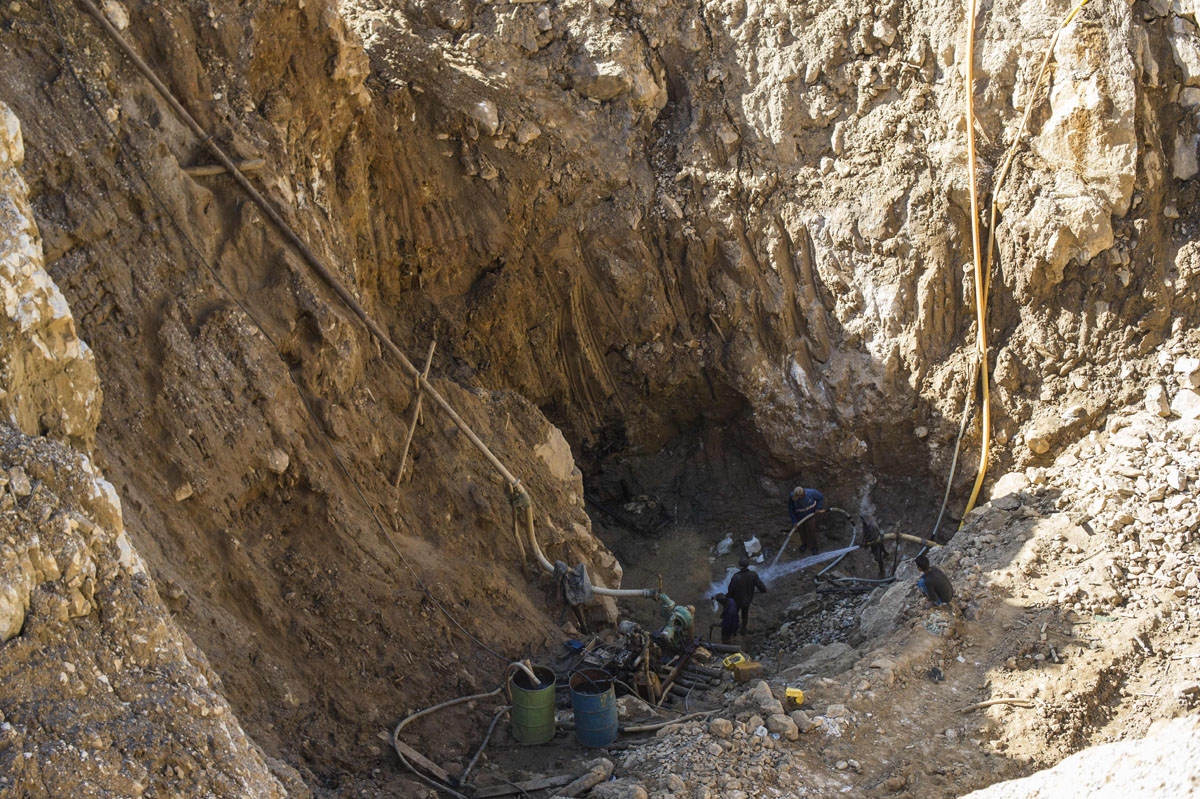 This photo taken on November 25, 2016 shows miners working in a ruby mine in Mogok, north of Mandalay.