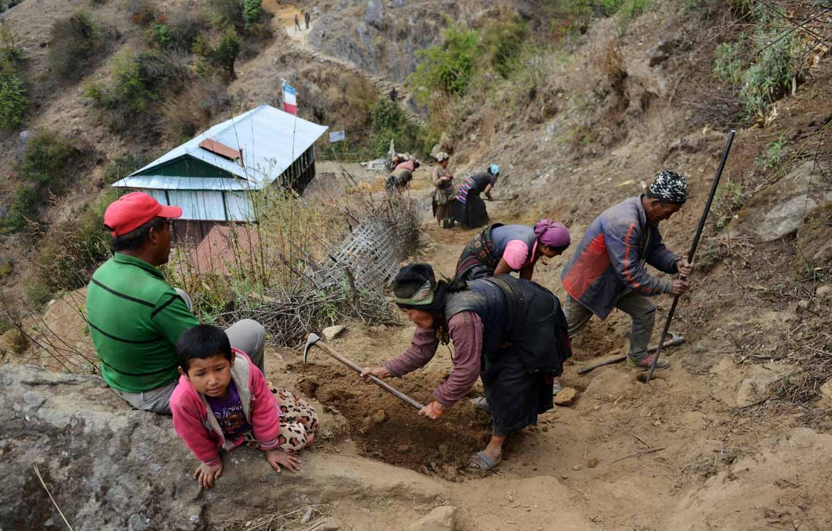 In this photograph taken on April 7, 2016, Nepalese workers restore a trail in Langtang valley in Nepal's Rasuwa district. In this photograph taken on April 7, 2016, Nepalese workers restore a trail in Langtang valley in Nepal's Rasuwa district.