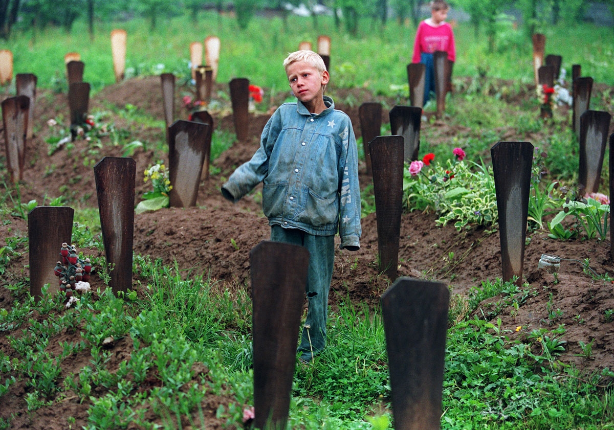 A Bosnian boy stands 06 May 1994 among the 200 graves in the Muslim cemetery in Ograndjenavac, Bosnia. On the seventh of May the Bosnian Croats and the Bosnian Muslims began a new series of peace talks at the US Embassy in Vienna.