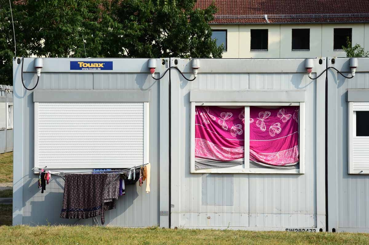 Laundry hangs outside a prefab housing unit for asylum seekers at centre for asylum seekers Zentrale Aufnahmestelle für Asylbewerber, in Eisenhuettenstadt, eastern Germany, near the Polish border, on August 13, 2015. Laundry hangs outside a prefab housing unit for asylum seekers at centre for asylum seekers Zentrale Aufnahmestelle für Asylbewerber, in Eisenhuettenstadt, eastern Germany, near the Polish border, on August 13, 2015.
