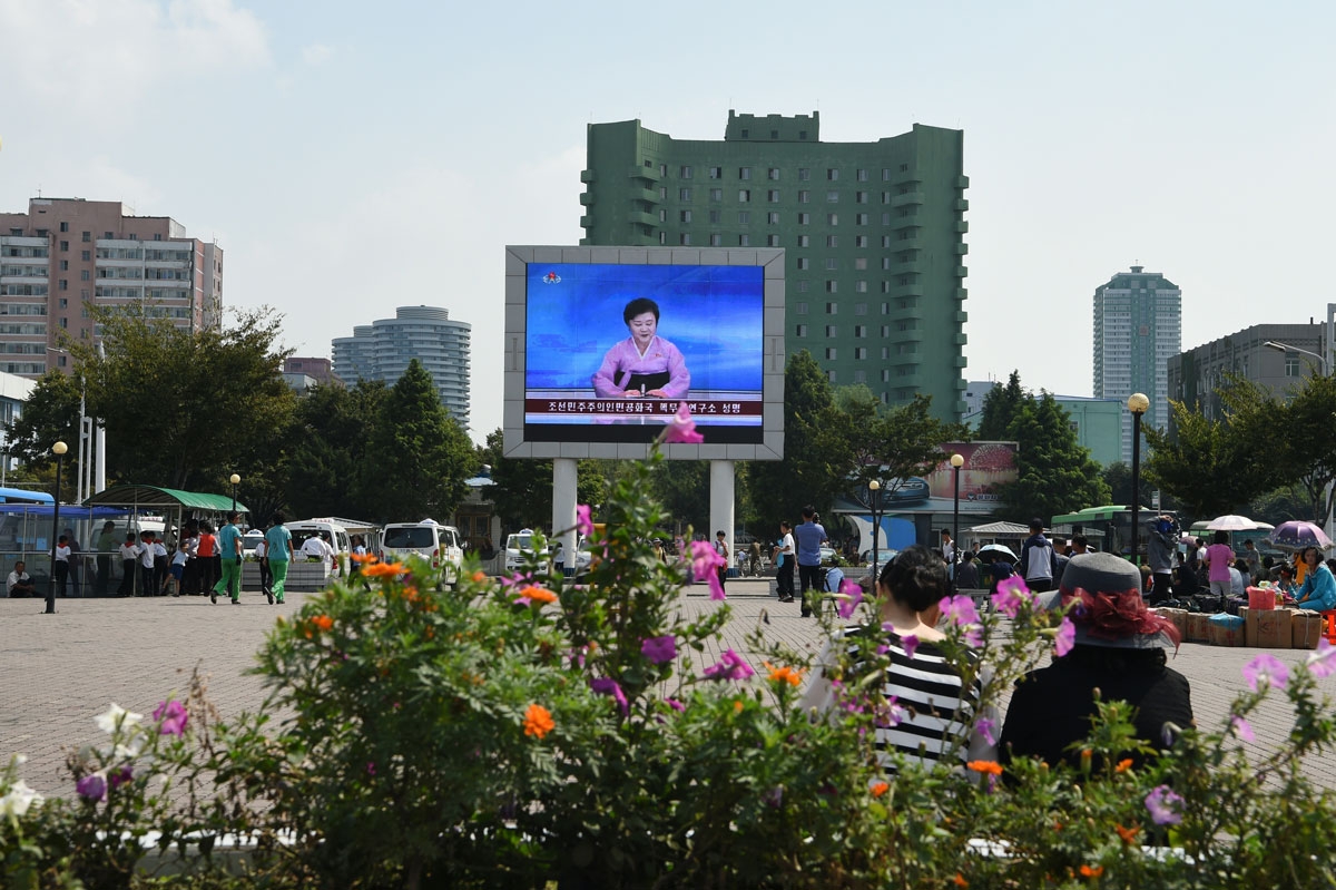 A big screen in front of Pyongyang railway station shows television presenter Ri Chun-Hee officially announcing that the country successfully tested a nuclear warhead earlier in the day on September 9, 2016