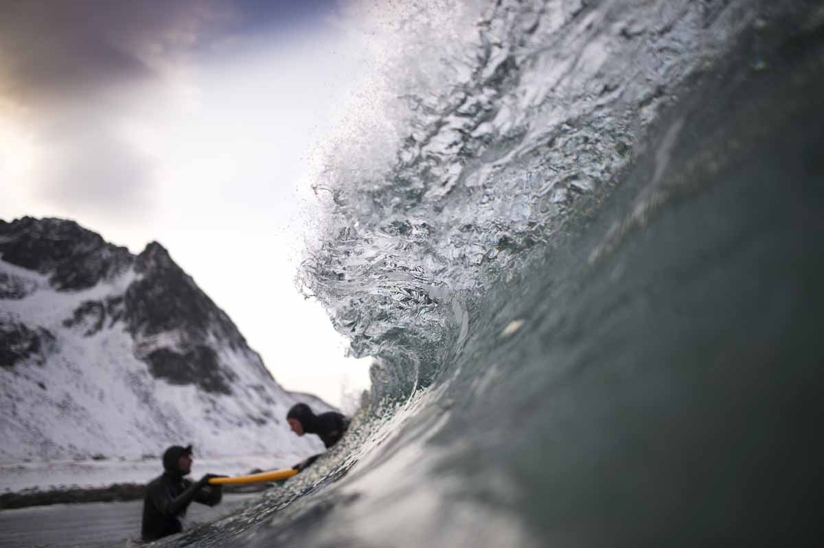 Norwegian surfer Tommy Olsen is seen in the water as he gives a surfing lesson to beginners in Flakstad, near Unstad along the northern Atlantic Ocean on March 9, 2017, where the water temperatures is at five degrees centigrade and the air temperature is
