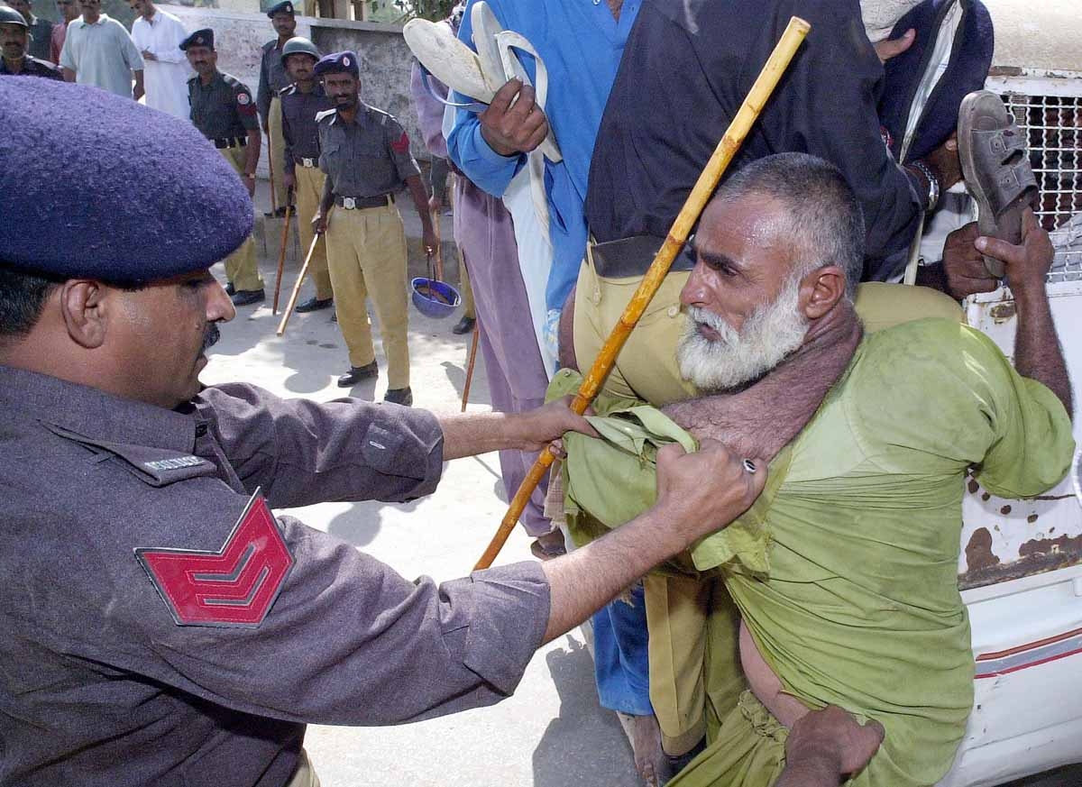 Pakistani policemen try to drag an elderly protestor in a bid to foil a demonstration in Jacobabad city, 500 kilometers northeast of Karachi, 23 October 2001. Pakistani policemen try to drag an elderly protestor in a bid to foil a demonstration in Jacobabad city, 500 kilometers northeast of Karachi, 23 October 2001.