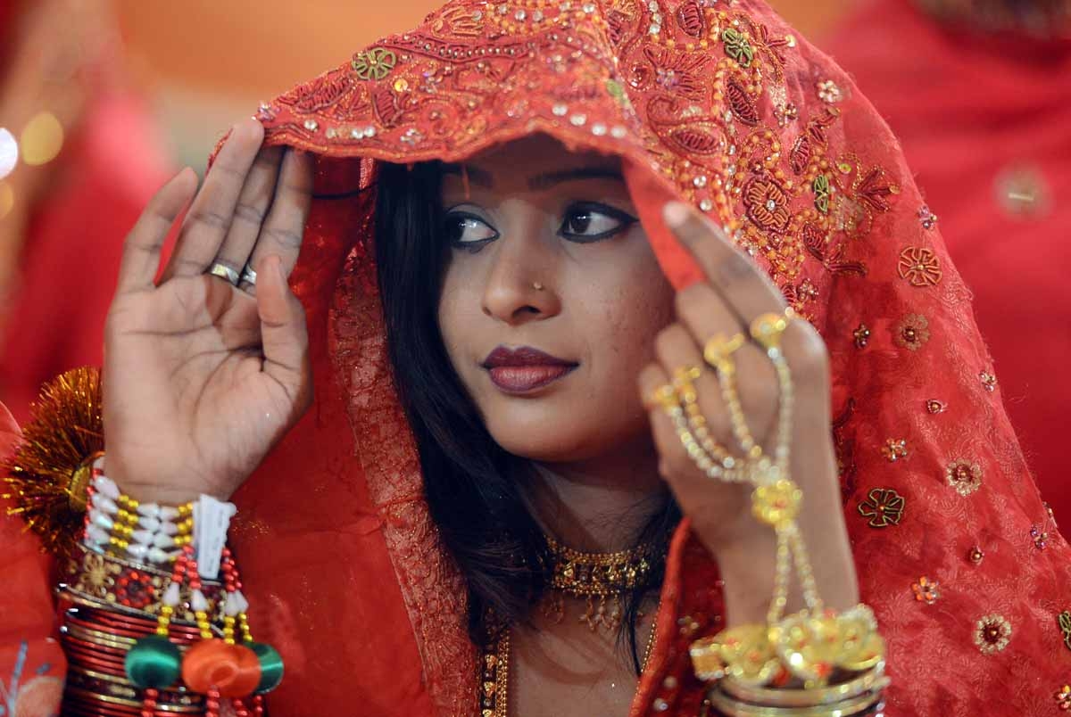 A Pakistani bride looks on during a mass marriage ceremony in Karachi late March 26, 2013. A Pakistani bride looks on during a mass marriage ceremony in Karachi late March 26, 2013.