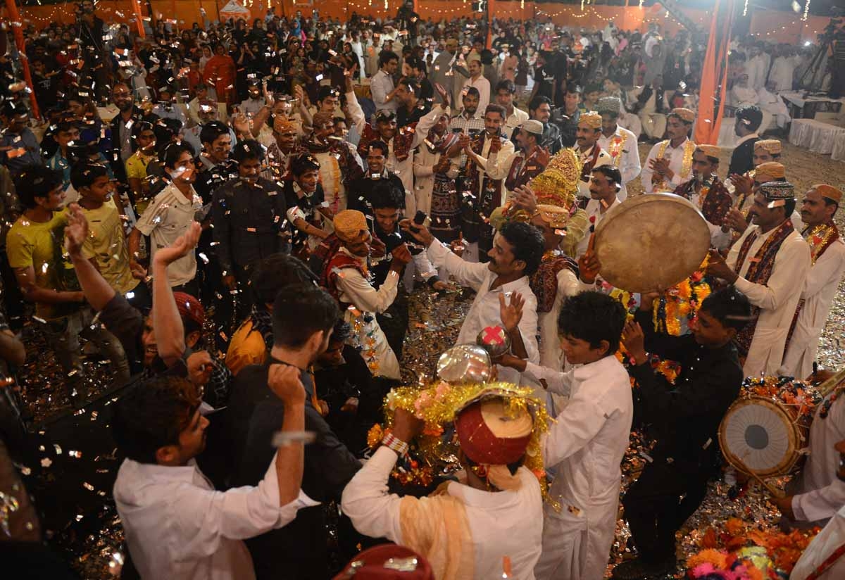 Pakistani grooms celebrate during a mass marriage ceremony in Karachi late March 26, 2013. Pakistani grooms celebrate during a mass marriage ceremony in Karachi late March 26, 2013.
