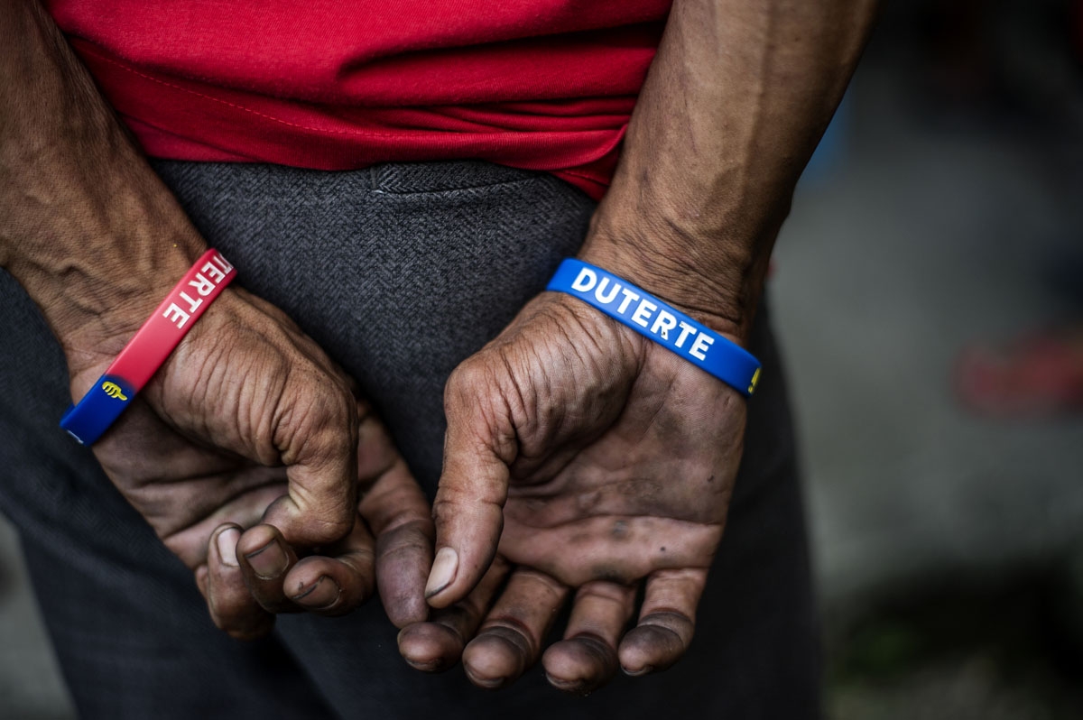 A suspected offender waits to undergo drug tests at Camp Karingal police station in Manila on June 24, 2016