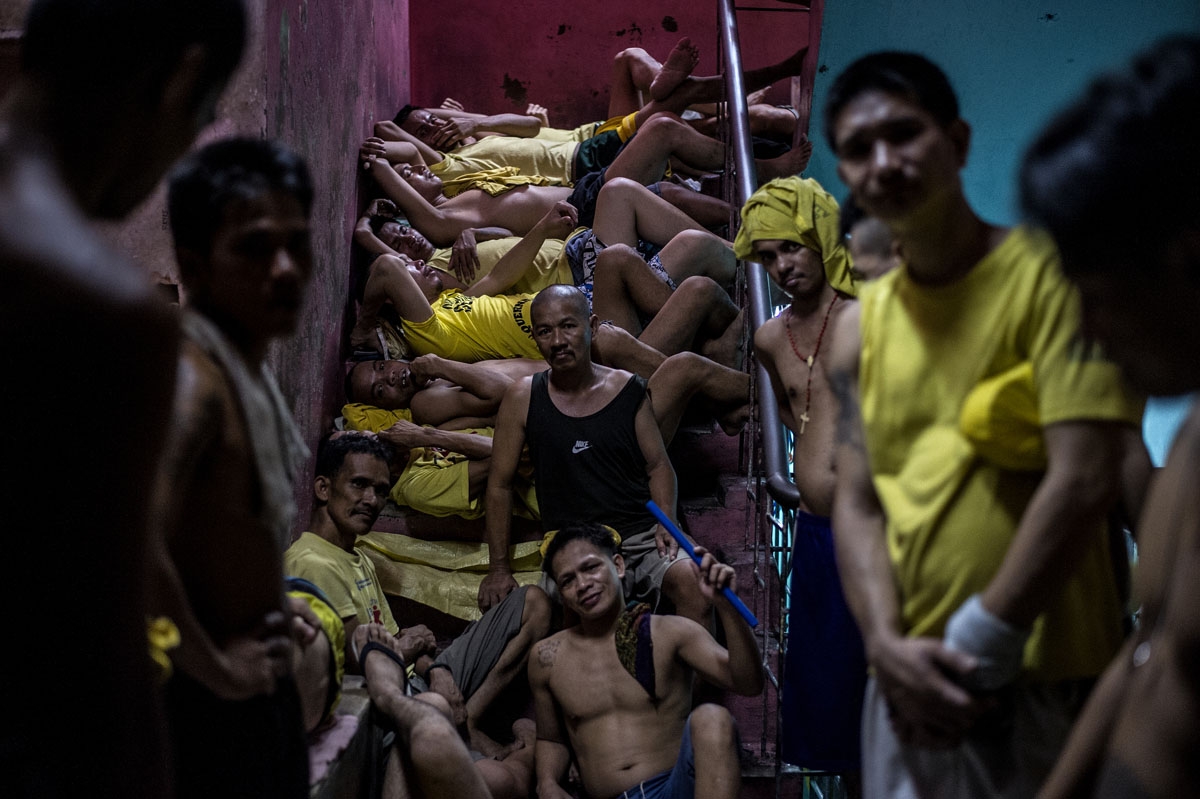 Inmates sleep on a staircase at the Quezon City jail on July 18, 2016